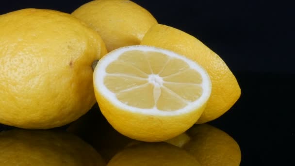Dojrzałe świeże soczyste żółta cytryna na czarnym tle obracać — Wideo stockowe