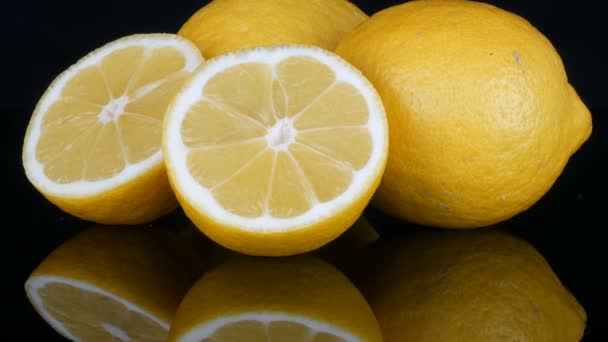 Ripe fresh juicy yellow lemon on black background — Stock Video