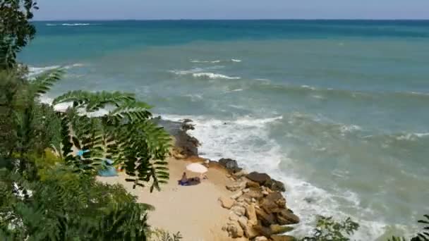 Vackert trefärgat hav med olika nyanser av turkos blå och mörkgrön färg med vågor och vitt skum. Stormvågor slår mot stenig strand — Stockvideo