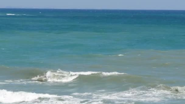 Beautiful tricolor sea with different shades of turquoise blue and dark green with waves and white foam on it — Stock Video