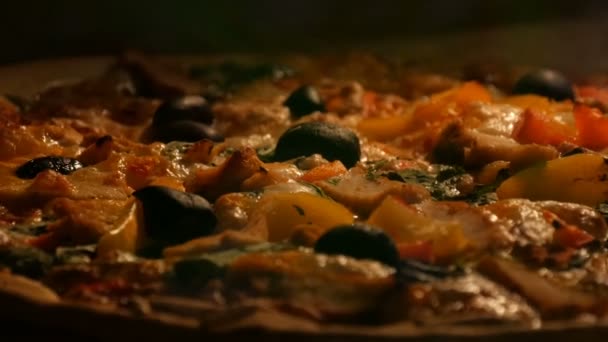 Delicious vegetarian pizza with black olives, paprika, mushrooms, vegetables and greens cooked in oven — Stock Video