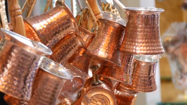 Beautiful shiny copper coffee turks hang in Istanbul market