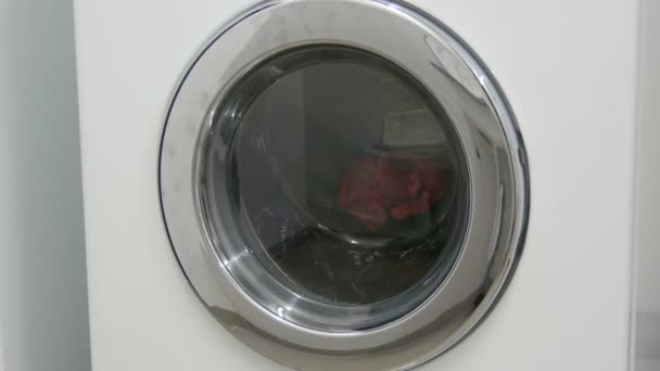 Laundromat Clothes tumble washing in a machine close up — 비디오