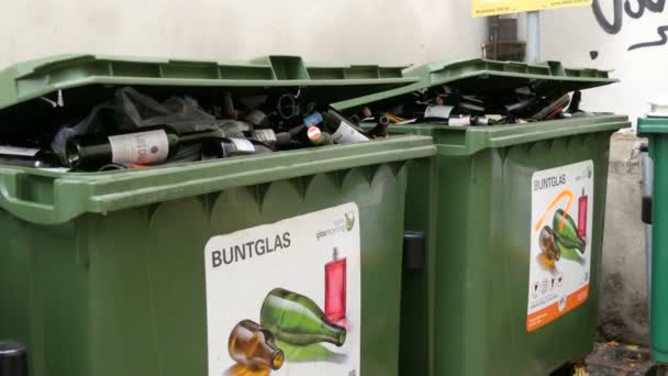 Vienna, Austria - December 19, 2019: Plastic garbage containers for colored glass bottles. Sorting and recycling garbage. Environmental protection, waste sorting. Inscription in german — 비디오