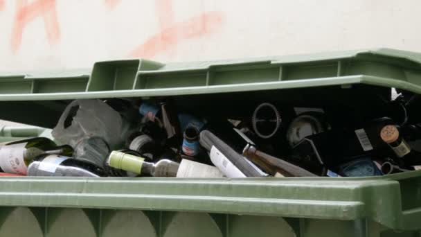 Vienna, Austria - December 19, 2019: Plastic garbage containers for colored glass bottles. Sorting and recycling garbage. Environmental protection, waste sorting. Inscription in german — 비디오