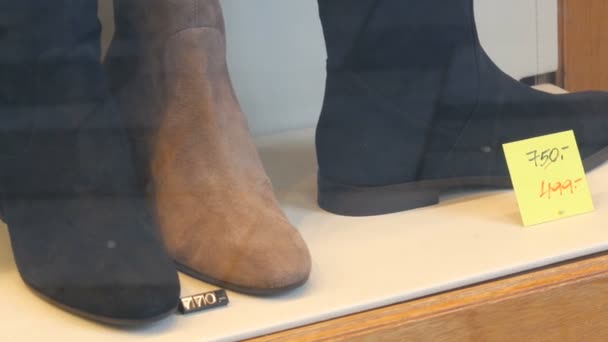 Стильная обувь из замшевой кожи на окне обувного магазина с ценниками и скидками — стоковое видео
