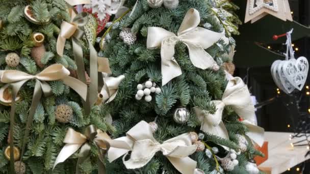 Beautifully decorated Christmas tree. White Christmas toys, bows, festive decor — 비디오