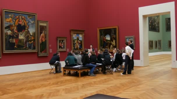 Múnich, Alemania - 17 de diciembre de 2019: Un grupo de visitantes a los amantes del arte discuten sobre pinturas. El viejo Pinakothek. Exposición de hermosas pinturas grandes mundialmente famosas de artistas — Vídeo de stock