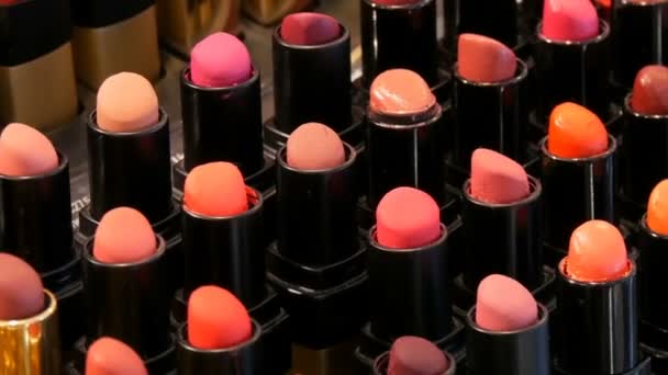 Tienda de cosméticos de moda de lujo. Soportes con variedad de lápices labiales de diferentes colores, cosméticos profesionales para mujeres — Vídeos de Stock