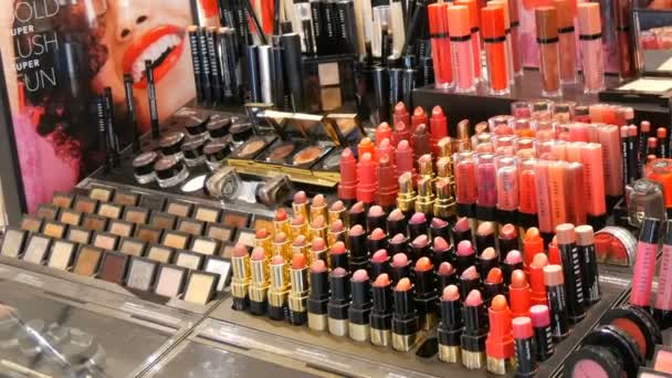 Amsterdam, Netherlands - April 25, 2019: Shop luxury fashion cosmetics. Stands with variety of decorative cosmetics, lipstick, mascara, gloss, eyeshadow — Stock Video