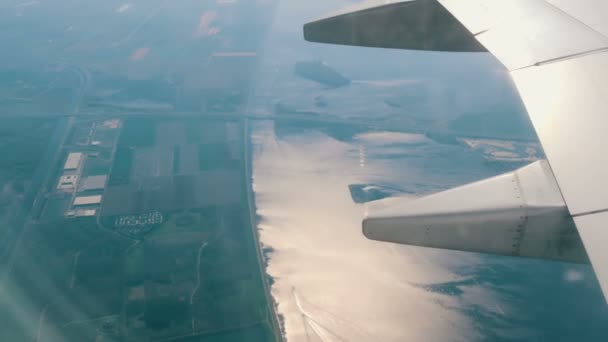 View of the large water channel near Amsterdam Holland, the Netherlands from the airplane porthole on the background of wing — Stock Video