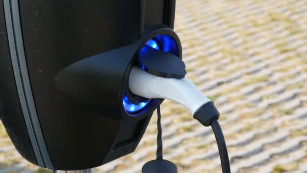 アムステルダム,オランダ- 4月24 、 2019:電気自動車は駐車場で充電しています。現代世界における生態系燃料。街中の充電ステーション — ストック動画