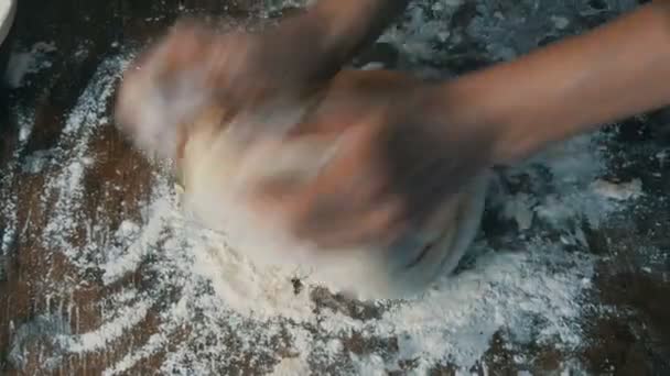Female hands knead fresh homemade dough on a special kitchen board in the home kitchen. Home baking pastries — Stock Video