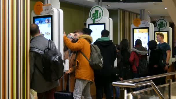 Vienna, Austria - December 19, 2019: Digital screen for orders without cashiers at McDonalds. People make fast food order using digital screen. Modern technologies without operators — Stock Video