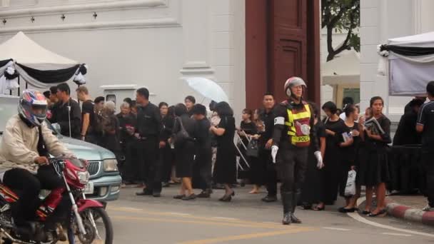 BANGKOK, THAILAND - LOKAKUU 31, 2016: Surijat jonossa poistua Grand Palace kunnioittaa myöhään kuningas Bhumibol Adulyadej kuin palatsi avataan ensimmäistä kertaa . — kuvapankkivideo