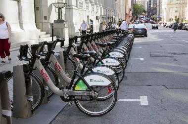 Shared bikes are lined up in the streets. First large-scale in North America city public bicycle sharing system Bixi. Bicycles in bike dock clipart