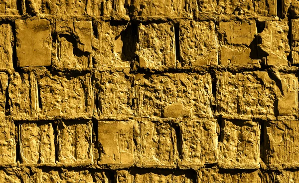 Złote piaszczyste kamienny mur szczegółowe tekstura tło — Zdjęcie stockowe