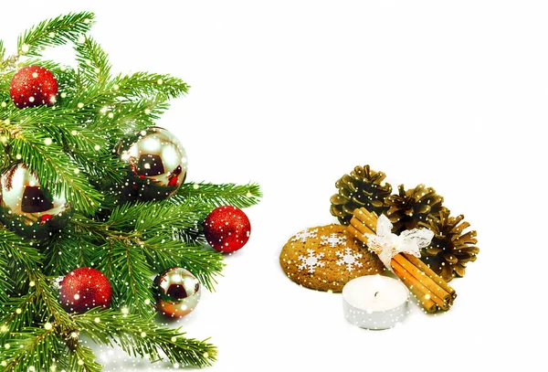 New year theme: Christmas tree, red balls, decorations, candle, snowflakes, cookies, cones, cinnamon isolated on white with shiny snowfall — Stock Photo, Image