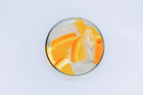 Top View Glass Cup Water Pieces Ice Orange Slices White — Stock Photo, Image