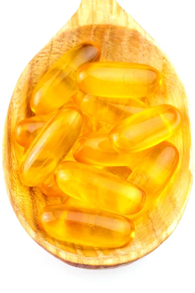 Colher cheia de ácido gordo, omega 3 cápsulas isoladas sobre fundo branco . — Fotografia de Stock