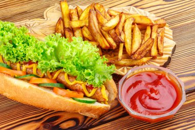 Fast food yemek, sosis, patates kızartması ve ketçap ahşap arka plan üzerinde.