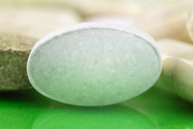 Natural food supplement pills, calcium tablet macro image, soft blurred background. clipart