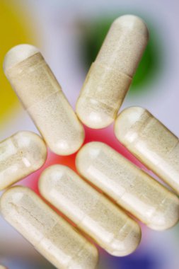 Glucosamine capsules, food supplement pills, top view, macro image. clipart