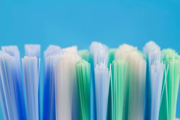 Macro photo of toothbrush isolated on blue background. — Stock Photo, Image