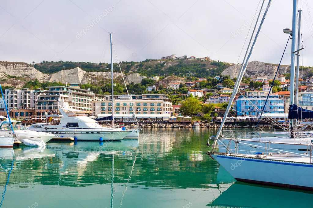 Yachts, sailing boats and pleasure boats are moored in marina of Balchik city in black sea coast at Bulgaria.