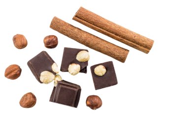 Fındıklı ve tarçınlı acı siyah çikolata parçaları beyaz arka planda izole edilmiş..