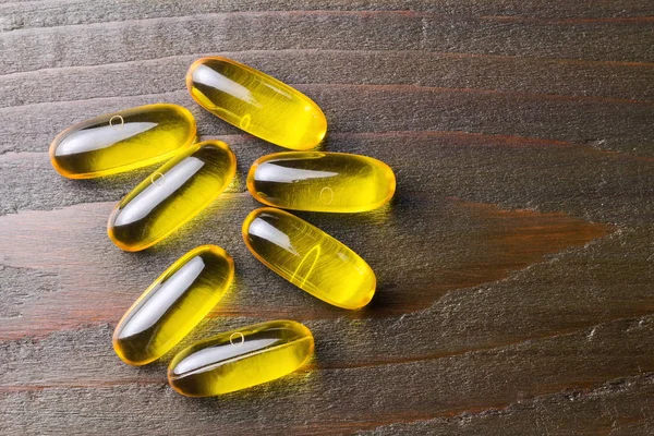 Yellow Capsules Omega Fatty Acid Fish Oil Dark Wooden Table — 스톡 사진