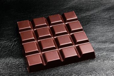 Karanlık, acı çikolata siyah deri doku arka plan üzerinde.