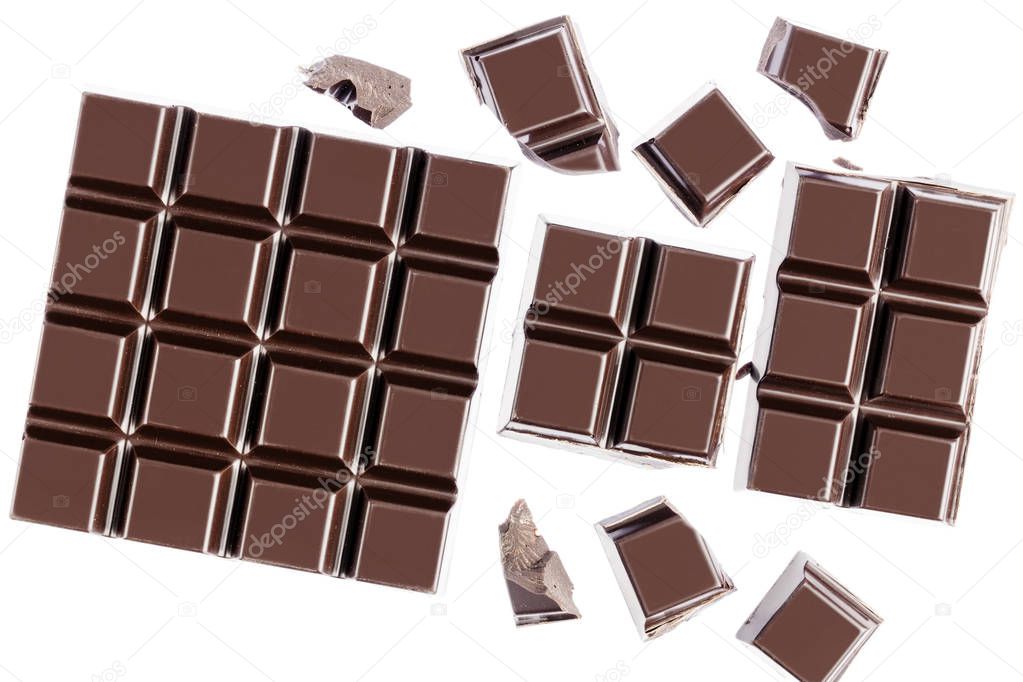 Chocolate cubes, pieces of bitter, dark chocolate bar, isolated on white background, top view.