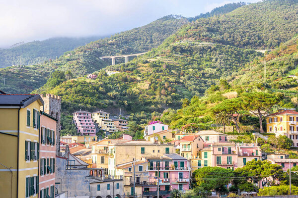 Daylight view to city buildings and green mountains of Monterosso al Mare, Italy. Cinque Terre