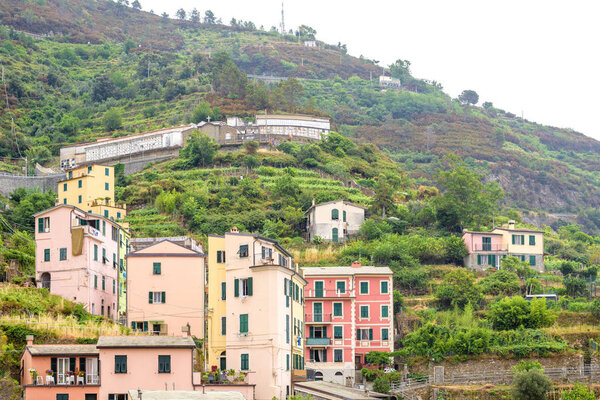 View to city buildings and mountains in a foggy day. Vernazza, Cinque Terre, Italy