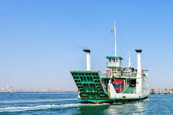 Daylight view to green loaded ferry cruising on water with trace — Stock Photo, Image