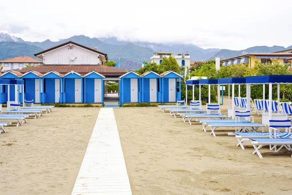 Nyári megtekintése a vibráló zöld sunchairs és napernyők a strandon — Stock Fotó