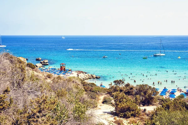 Daylight view from top to Konnos beach with people relaxing — Stock Photo, Image