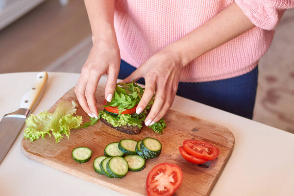 Woman hands making a healthy sandwich