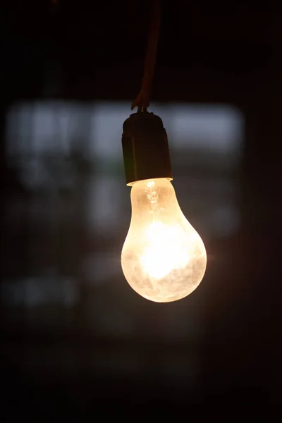 Warm light bulb in a dark space