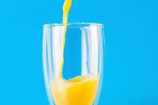 Apelsinjuice Häller Gräs Blå Bakgrund Häll Juice Glas — Stockfoto