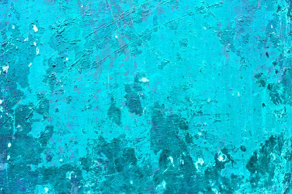 Cracked and peeling paint on the blue wall. Close-up view. Grunge old texture. Scratched and chipped surface. — Stock fotografie