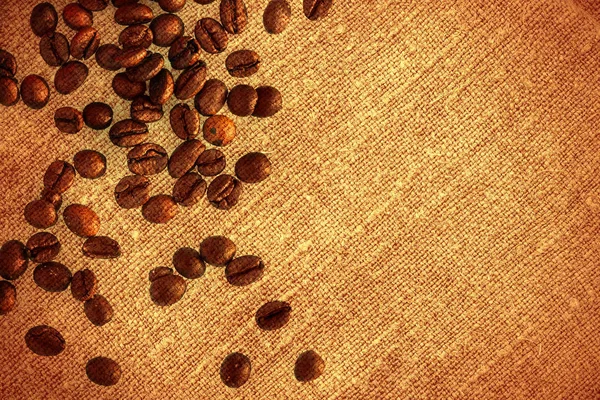 Koffiebonen op bruin linnen achtergrond — Stockfoto