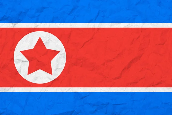 북한의 국기입니다. 빈티지 스타일입니다. 오래 된 벽 텍스처입니다. 어두운된 배경. — 스톡 사진