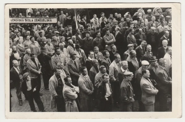 Vintage photo shows people celebrate May Day (International Workers' Day). Retro black & white  photography.