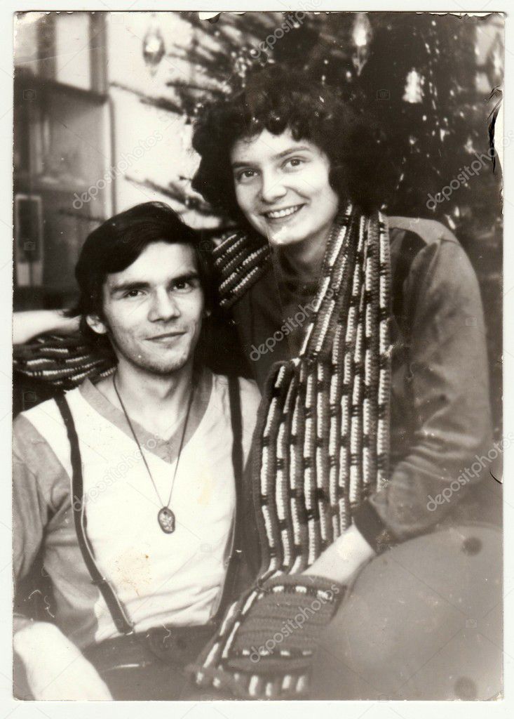  Vintage photo shows an adolescent  couple during Christmas. Retro black & white  photography.