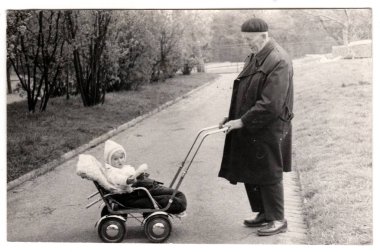 Vintage Fotoğraf dedesi küçük bebek arabası (taşıma) gösterir. Retro siyah ve beyaz fotoğraf 