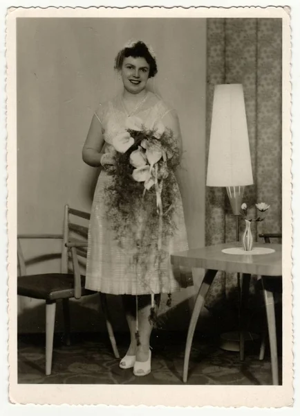 Archiwalne zdjęcie pokazuje panny młodej. Panna młoda nosi miękkie welon i posiada kwiaty calla (bukiet). Retro czarny & biały Fotografia. — Zdjęcie stockowe
