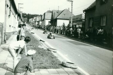 Retro photo shows  go-karts racing on the street. Vintage photography. clipart