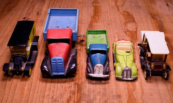 Oldtimer-Spielzeugautos (LKW und Cabrio) auf braunem Holzgrund. Retro-Spielzeug für Jungen. flache Bauweise mit Leer- und Freiraum. — Stockfoto